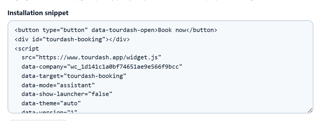 The installation snippet starting with a Book now button that has the data-tourdash-open attribute, followed by the widget script.